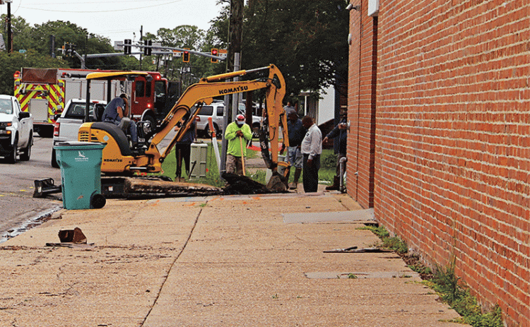 Workers repair a gas leak in the alley behind the Prairie Acadian Cultural Center off South 3rd Street on Monday. The leak caused the evacuation of about 50 people and the closing of about 15 businesses in the downtown area. (Photo by Myra Miller)