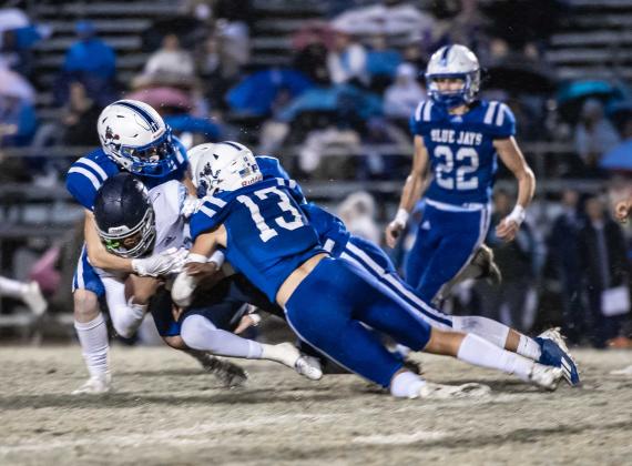 St. Ed's Copeland Miller and several Blue Jay defenders surround WCA ball carrier Stephen George. (Photo by Dwight Jodon)