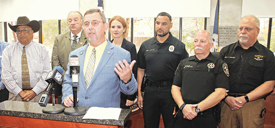 St. Landry Parish President Jessie Bellard announced on Thursday parish law enforcement agencies would share in $1.8 million in federal funding for technology upgrades such as body cameras and radios. From left, are Opelousas City Marshal Paul Mouton, Sheriff Bobby Guidroz, Bellard, Assistant District Attorney Alisa Gothreaux, Opelousas Police Chief Graig LeBlanc, Eunice City Marshal Terry Darbonne and Eunice Police Chief Kyle LeBouef. (Photos by Harlan Kirgan)