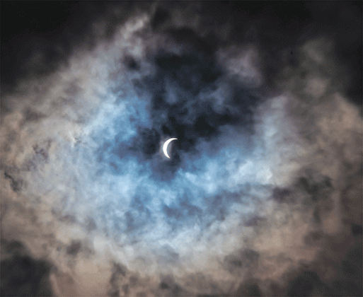 Eunice photographer Dwight Jodon captured a photo of the eclipse peaking through the clouds on Monday. 