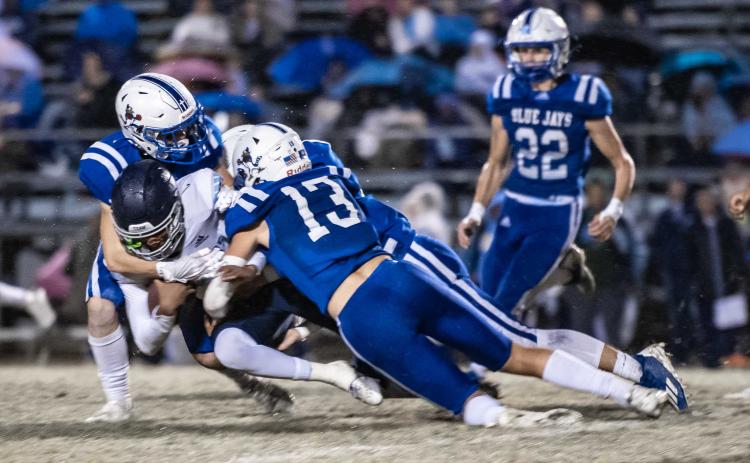St. Ed's Copeland Miller and several Blue Jay defenders surround WCA ball carrier Stephen George. (Photo by Dwight Jodon)