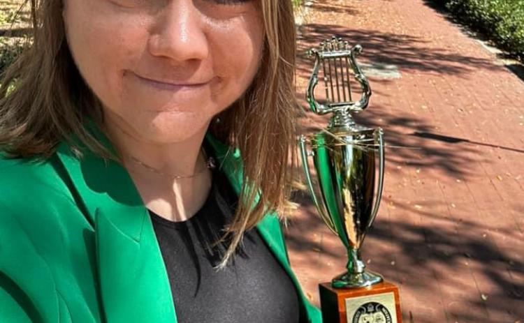 Emily Young, band director at Central Middle and Eunice Jr. High, and her band students recently participated in a district music competition. They came home with a trophy and superior top ratings. (Submitted photos)