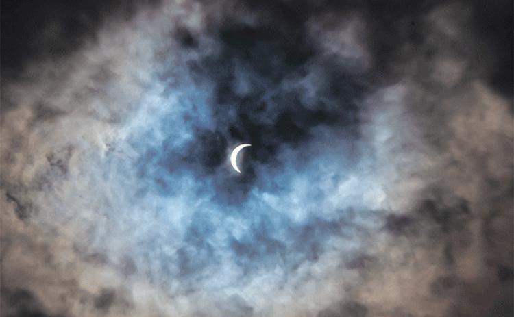 Eunice photographer Dwight Jodon captured a photo of the eclipse peaking through the clouds on Monday. 