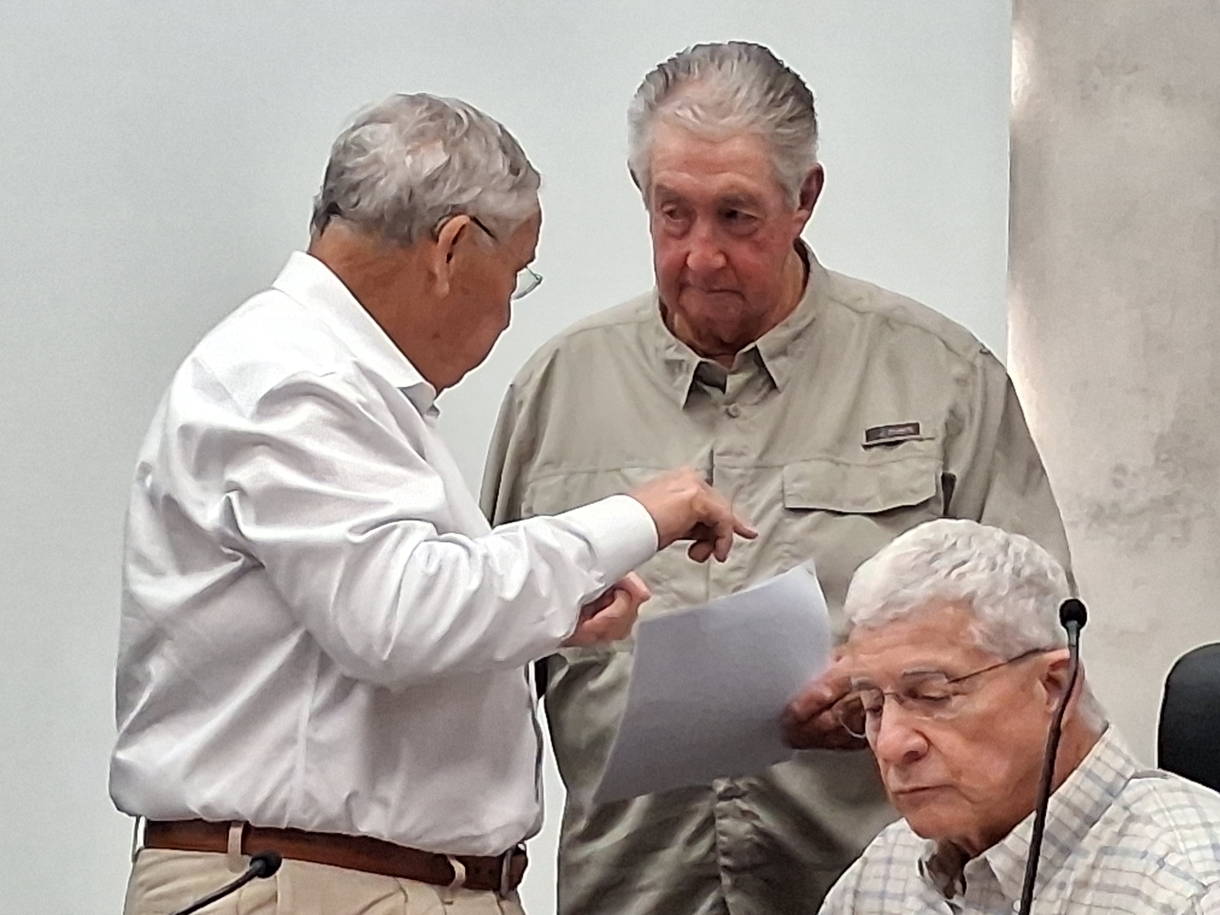 Council member Harold Taylor discusses an issue with council member Alvin Stelly