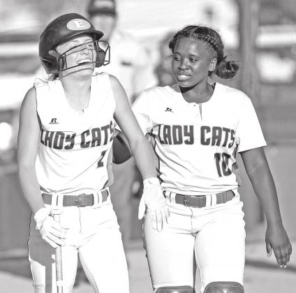 Eunice High’s Sophie Vidrine, left, and McKenzie Guillory celebrate after Vidrine’s home run against Washington-Marion. (Photo by Tom Dodge)