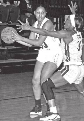 LSUE‘s Alona Washington looks to pass the ball as MGCCC’s Aniya Saddler defends on the play. Washington led the Lady Bengals with 14 points. (Photo by Tom Dodge)