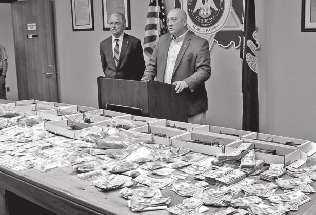 Acadia Parish Sheriff K.P. Gibson, right, addresses media Thursday morning concerning a recently completed 45-day operation that resulted in the confiscation of numerous illegal handguns, a variety of narcotics and currency. Looking on is District Attorney Don Landry. (Photo by Steve Bandy/Crowley Post-Signal)