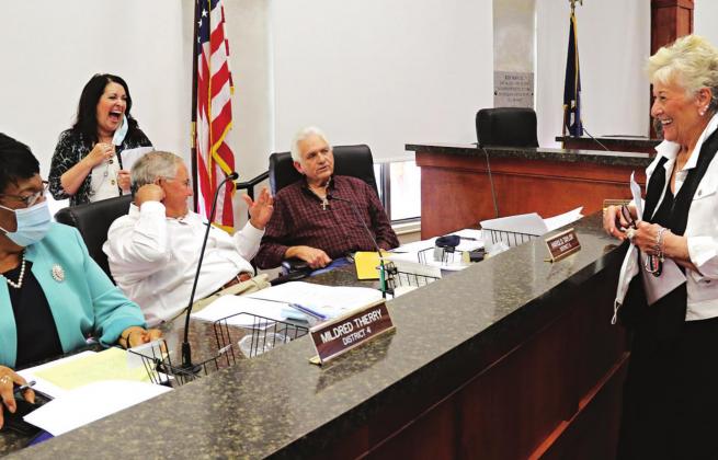 Former Eunice Mayor Lynn LeJeune, right, chats with St. Landry Parish Council members, seated from left, Mildred Thierry, Harold Taylor and Gil Savoy; and Amanda Cain, parish government finance officer, at Wednesday Parish Council meeting. LeJeune is Krotz Springs Port director. She was there with Pat Dossman, Dwight Jodon and Charles Seale to invite Council members to a tour of the Liberty Theatre. (Photo by Harlan Kirgan)