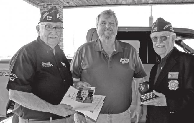 Thomas Stevens was honored and recognized by the Auxiliary and Post as High School Teacher of the Year at St. Edmund High School. From left, are Olivier, Stevens, and Reber.