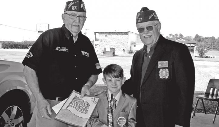 The VFW Post 8971 and Auxiliary held its annual Americanism Essay winners by means of a drive-thru ceremony Saturday. Sylas Brown, a second grader at East Elementary placed second in the Americanism essay contest presented by the VFW and Auxiliary. From left, are Gene Olivier, Brown, and Don Reber.