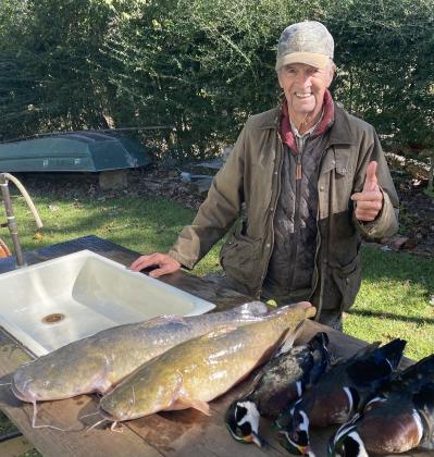 T Clause shown with his catch, spotted catfish and wood ducks.
