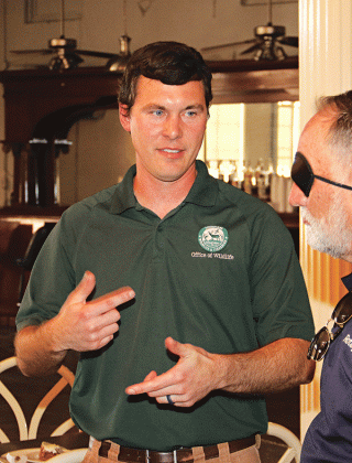 Dustin Champagne, a wildlife biologist with the Louisiana Department of Wildlife and Fisheries, speaks with Eunice Rotarian Randall Vige at Wednesday’s meeting. (Photo by Harlan Kirgan)