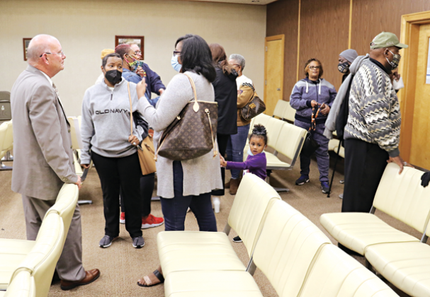 Eunice Police Chief Randy Fontenot, let, visited with people after Tuesday’s city meeting. (Photo by Harlan Kirgan)