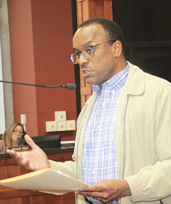 Herman Fuselier, St. Landry Parish Tourist Commission executive director, reviews tourism statistics at the St. Landry Parish Council meeting on Wednesday in Opelousas. (Photo by Harlan Kirgan)