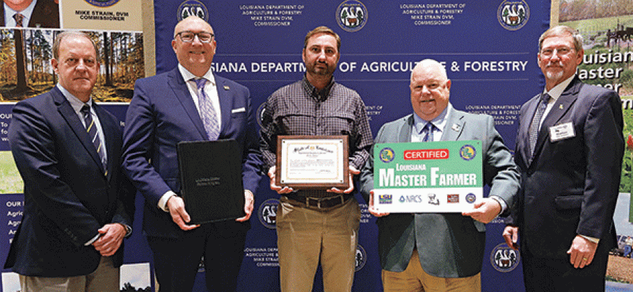 Trent Broussard, of Acadia Parish, was designated a Louisiana Master Farmer at a Jan. 12 ceremony. From left, are Michael Salassi, director of the Louisiana Agricultural Experiment Station; Matt Lee, interim LSU vice president for agriculture; Broussard; Mike Strain, commissioner of the Louisiana Department of Agriculture and Forestry; and Chad Kacir, of the Natural Resources Conservation Service. (Photo by Olivia McClure/LSU AgCenter)