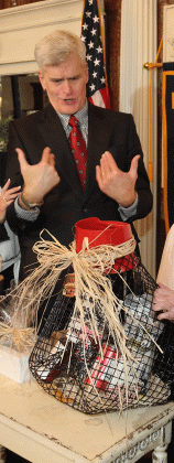 Sen. Bill Cassidy looks over a crawfish trap filled with gifts. (Photo by Harlan Kirgan)