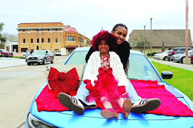 Simphany Thomas, 6, and Kahmari Johnwell, 17, rode in the MLK Parade Saturday. The girls represented New Zion Baptist Church.