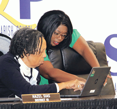 St. Landry Parish School Board members Hazel Sias and Timmakah Hardy confer at Monday’s meeting. (Photo by Harlan Kirgan)
