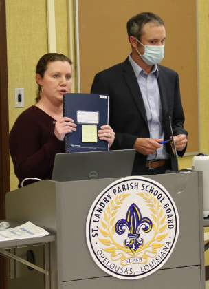 Tressa Miller, right, St. Landry Parish School Board finance director, holds an audit report up. At right is Casey Ardoin, CPA, of the Kolder, Slaven &amp; Company. They were at the School Board’s Finance Committee meeting Monday in Opelousas. (Photo by Harlan Kirgan)