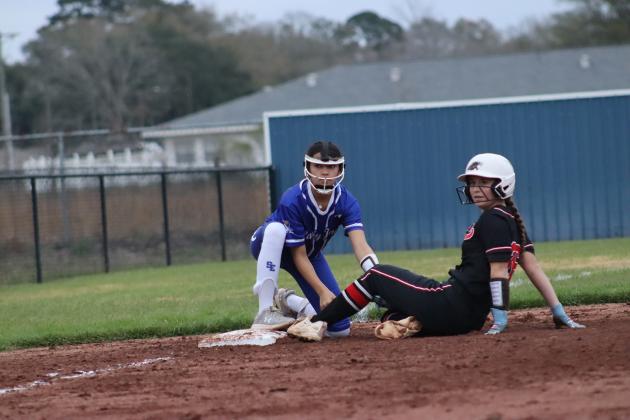 Pictured is St. Ed player Rory Langlinais tagging a Bunkie player out at third base. (Photo by Amy Myers)