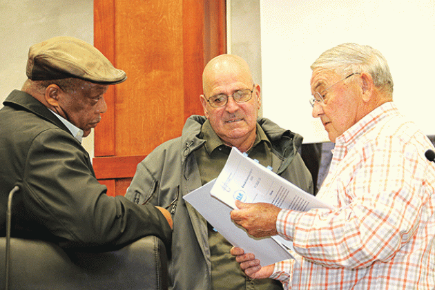 St. Landry Parish Council members, from left, Jerry Red, Timmy Lejeune and Harold Taylor at Tuesday’s special Council meeting. Taylor is holding a copy of Local Government Budget Act prior to the start of the meeting.