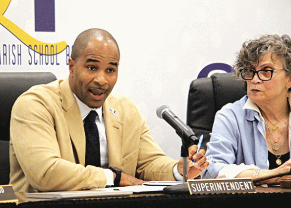 St. Landry Parish School Superintendent Milton Batiste talks about the weather extremes in January as Board President Mary Ellen Donatto listens at Thursday’s meeting in Opelousas. (Photo by Harlan Kirgan)