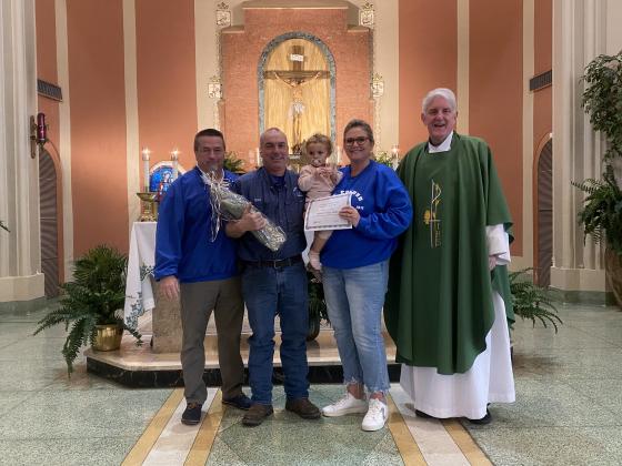 Supporters of the Year at St. Edmund were honored. From left, are Mitch Fontenot, Brad Miller, Tonya Miller with granddaughter Claire; and the  Rev. Hampton Davis.