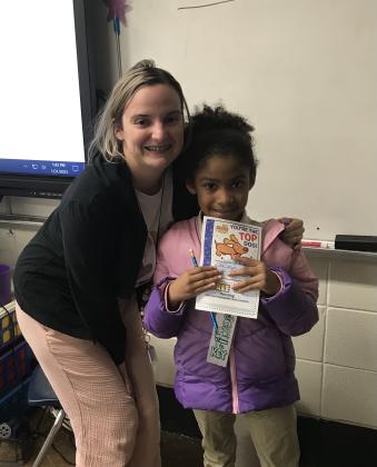 Accelerated Reading Awards were given to students at East Elementary who have reached their award points level. Kynzleigh Frank, a second grader, reached her 25 AR points. She is with her teacher Kimley Triplett.