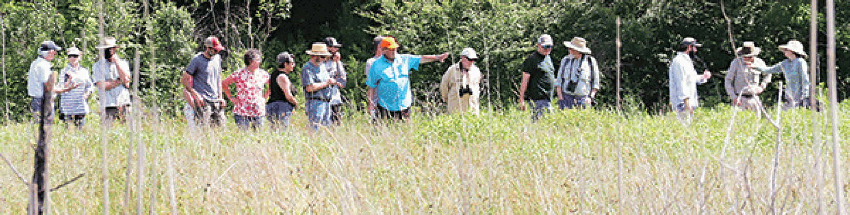 Dr. Malcolm Vidrine, center in the blue shirt, helps guide a tour of the 10-acre Cajun Prairie Restoration Project in Eunice in 2021. (Photo by Harlan Kirgan)