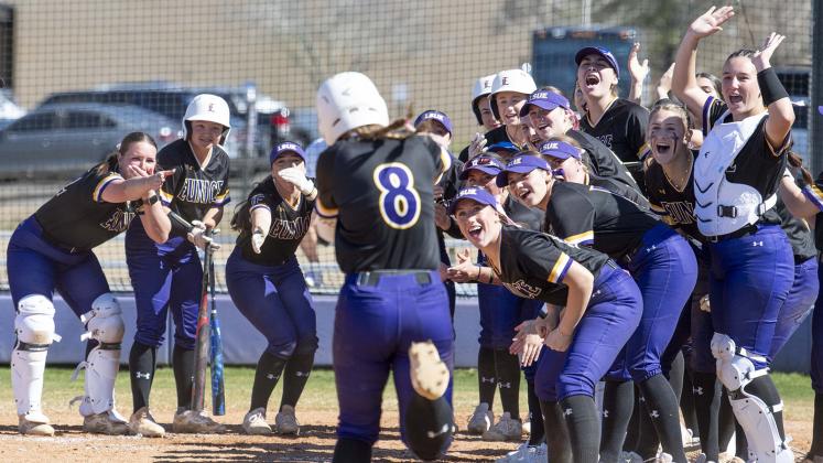 Jordan Stanley (8) met by teammates at home plate after hitting a home run vs. Kirkwood. (Photo by Travis Webb)