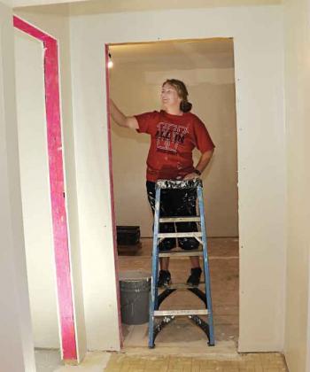 Tiffany Gal, of Rittman, Ohio, paints in the Church Point house. The remodeling of the house should be completed this week.  (Photo by Harlan Kirgan)