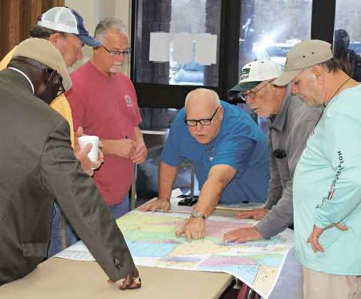Prior to the start of Thursday night’s redistricting meeting, members of both the Acadia Parish School Board and the Acadia Parish Police Jury discuss the proposed new lines. From left, are Bishop James Proctor, School Board District 1; Gordon Ray Morgan, Police Jury District 4; Ike Richard, School Board District 6; Doug LaCombe, School Board District 2; Pat Daigle, Police Jury District 7; and James Higginbotham, School Board District 7. (Photo by Steve Bandy/Crowley Post-Signal)