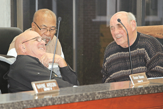 St. Landry Parish Council members, from left, Timmy Lejeune, Jimmie Edwards and Ernest Blanchard enjoy a conversation before Wednesday’s Parish Council meeting in Opelousas. (Photo by Harlan Kirgan)
