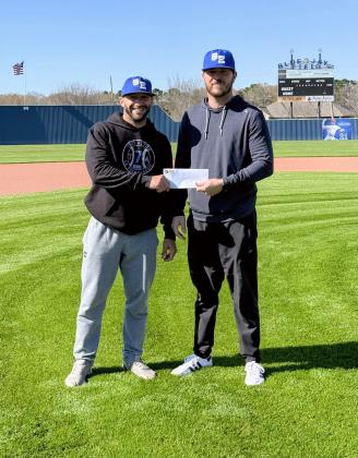 St. Edmund head coach Casey Charlie, left, and Stefan Frey of Frey Development stand at the Blue Jay Field as Frey Development announces its sponsorship of the upcoming Frey Development Prep Classic, set for Feb. 26–28.