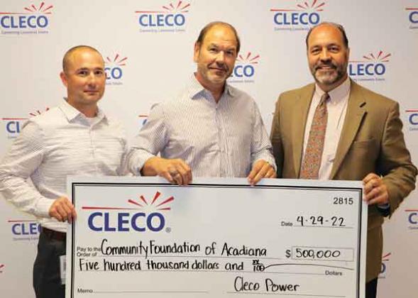 Andre Guillory, left, vice president and chief customer officer, and Bill Fontenot, center, president and CEO of Cleco Corporate Holdings, present a $500,000 check to Raymond Hebert, right, CEO of the Community Foundation of Acadiana. (Submitted photo)