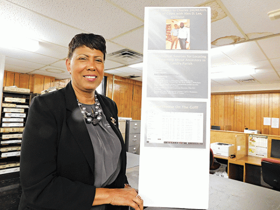 St. Landry Parish Clerk of Court employee Debra Sostand displays one of the several exhibits. (Submitted photo)