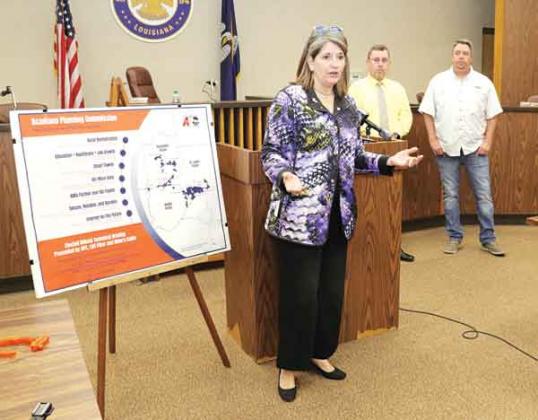 Monique Boulet, chief executive officer of the Acadiana Plannning Commission, explains a project to provide fiber-optic cable in the Tri-Parish area. A $29.9 million federal grant and the participation of LUS and Allen Cable will mean the installation of about fiber to about 22,500 households. At right are Parish President Jessie Bellard and Eunice Mayor Scott Fonteot.(Photos by Harlan Kirgan)