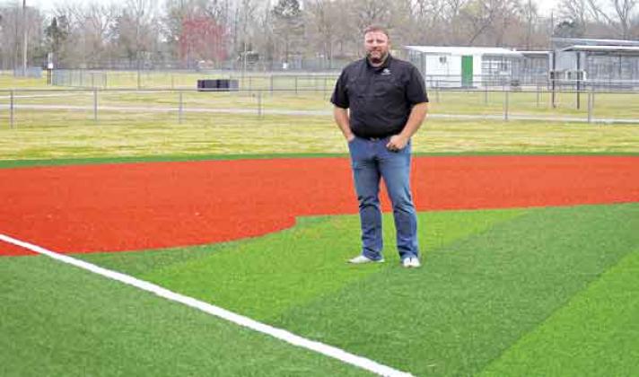 Robert Johnson, the city’s recreation director, stands on the infield turf at the Recreation Complex. (Photo by Tom Dodge)