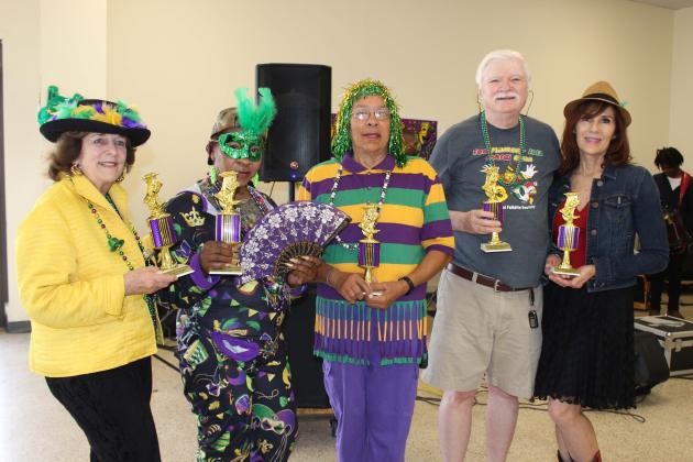Trophies winners in different categories were named at the conclusion of the St. Landry Council on Aging Mardi Gras dance Monday. From left are JoAnne Landreville, Prettiest Costume; Dianne Freeman, Most Traditional Costume; Margaret White, Most Creative Costume; Don Baggett, Best Male Dancer; and winning Best Female Dancer Penny Morris. (Photos by Myra Miller)