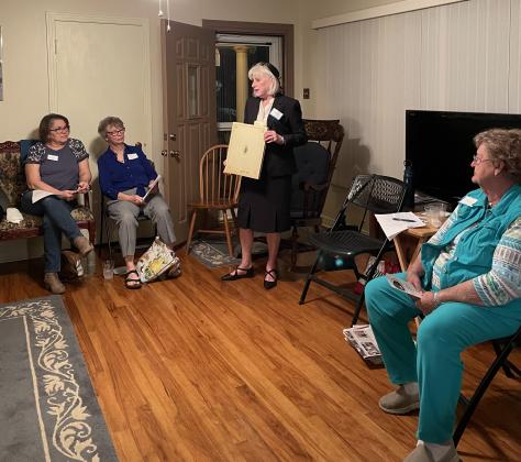 Pam Quirk, long time member of the Bulb &amp; Blossom Club modeled the attire that would have been worn by members back in 1948 when the club was founded. Pictured, from left, are Delana Dubroc, Erin Jones, Quirk, and Dean Deshotel. (Submitted photos)