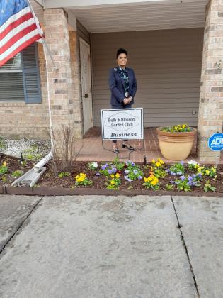 Angelia Guillory accepts the Bulb's Business Garden of the Month marker
