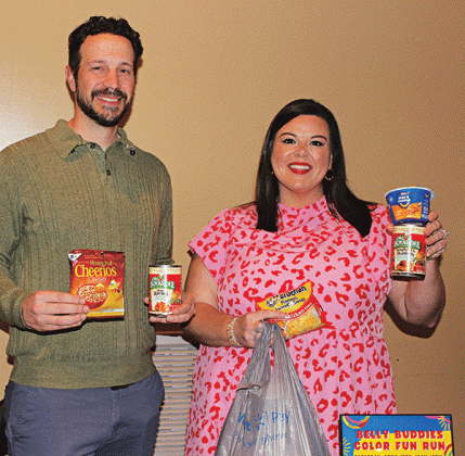 Belly Buddies, a program to fight childhood hunger, has been in existence nearly 10 years, and is hoping to expand. Chad Andrepont, the board president; and Katie Richard, the founder and executive director of the non profit program are with food items. Suggested food items are ones that are easy to open and prepare by a child. (Photo by Myra Miller)