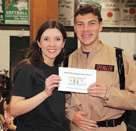 Jade Fontenot, a teacher at Eunice High, presents a $100 cash reward to Eunice High School’s Student of the Year Philippe Soileau during the school’s Renaissance Pep Rally. (Photo by Myra Miller)
