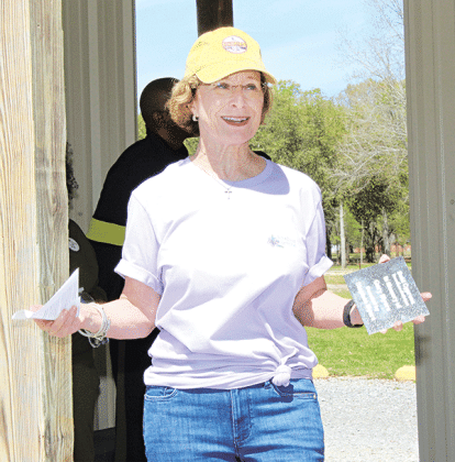 Celeste Gomez holds one of the markers used at trees in the Walking Park. Gomez was president of the Biub and Blossom Garden Club in 2024 and the tree markers were her signature project.