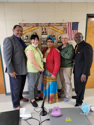 Left, Julius Alsandor, Mayor of Opelousas;  Kim Gaspard, Bonnie Ventress, Stephanie Speyer and the Rev. Allen Ben of New Zion Baptist Church were guests at Eunice Elementary.