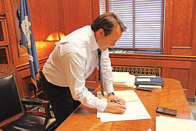 Speaker of the House of Representatives and Rep. Phillip DeVillier signs bills that were passed in the House on March 18. (Photo by Claudette Olivier/Crowley Post-Signal)