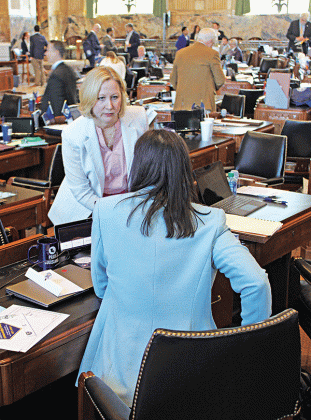 Clerk of the House of Representatives Michelle Fontenot speaks to a representative prior to the start of a legislative session on March 18. Fontenot is a native of Eunice. (Photo by Claudette Olivier/Crowley Post-Signal)