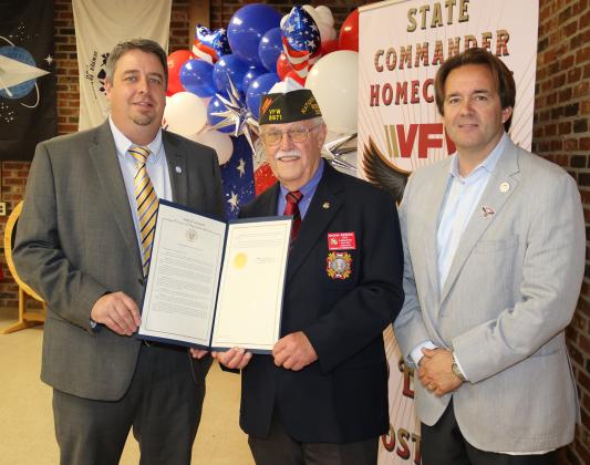 State Rep. Phillip DeVillier, right, presented an expression of condolences to the family of former Eunice Police Chief Gary “Goose” Fontenot to the chief’s son, Mayor Scott Fontenot, left, during VFW State Commander Don Reber’s State Commander Homecoming on April 1. The statement gave history of the former chief’s service that included service in the Army during the Vietnam War at the age of 17. The chief was elected to three terms. Chief Fontenot also served as commander of VFW Post 8971. (Photo by Harlan