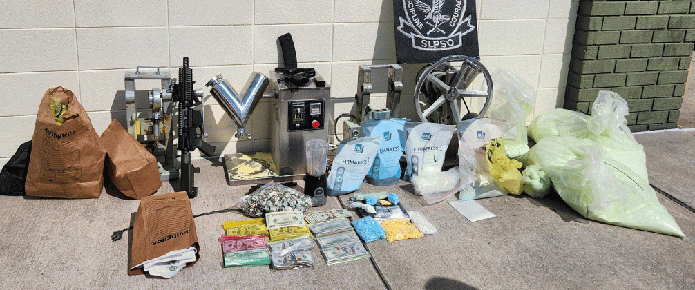 Drugs, guns and pill-making gear seized in drug bust. (St. Landry Parish Sheriff's Office photo)