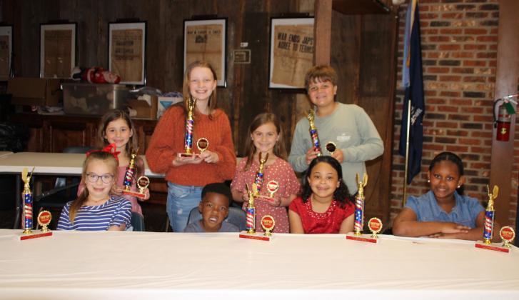 The VFW Post 8971 and Auxiliary honored students who placed in their annual Americanism essays contest. Students were awarded with cash prizes, plaques and trophies during a banquet held Wednesday evening. Seated, from left, are Allison Clark, Khaysten Frank, Madison Guillory,  and Ava Bushnell. Standing, from left, are JoAnn Leger, Olivia Smith, Kennedy LaFleur and Cooper DeVillier. Not pictured are Addaleigh Collins, and Alice Bellard. (Photos by Myra Miller)